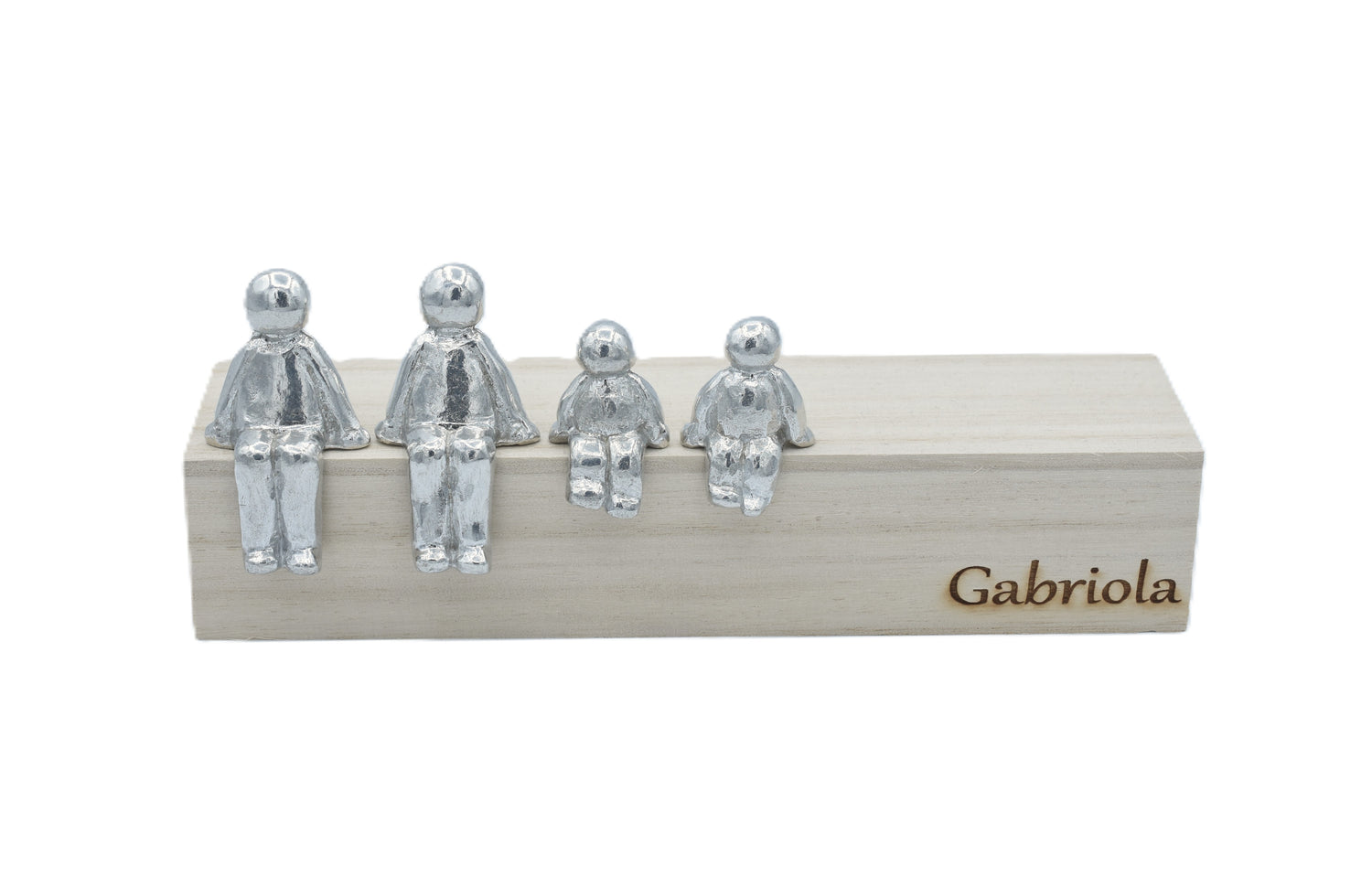 Four silver figures on a wooden block with 'Gabriola'font branding.